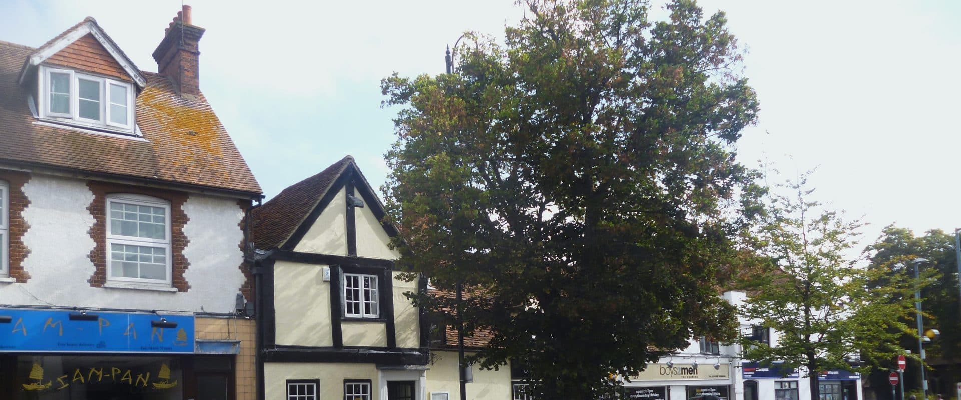 High Street in Stevenage Old Town lined with shops and street trees