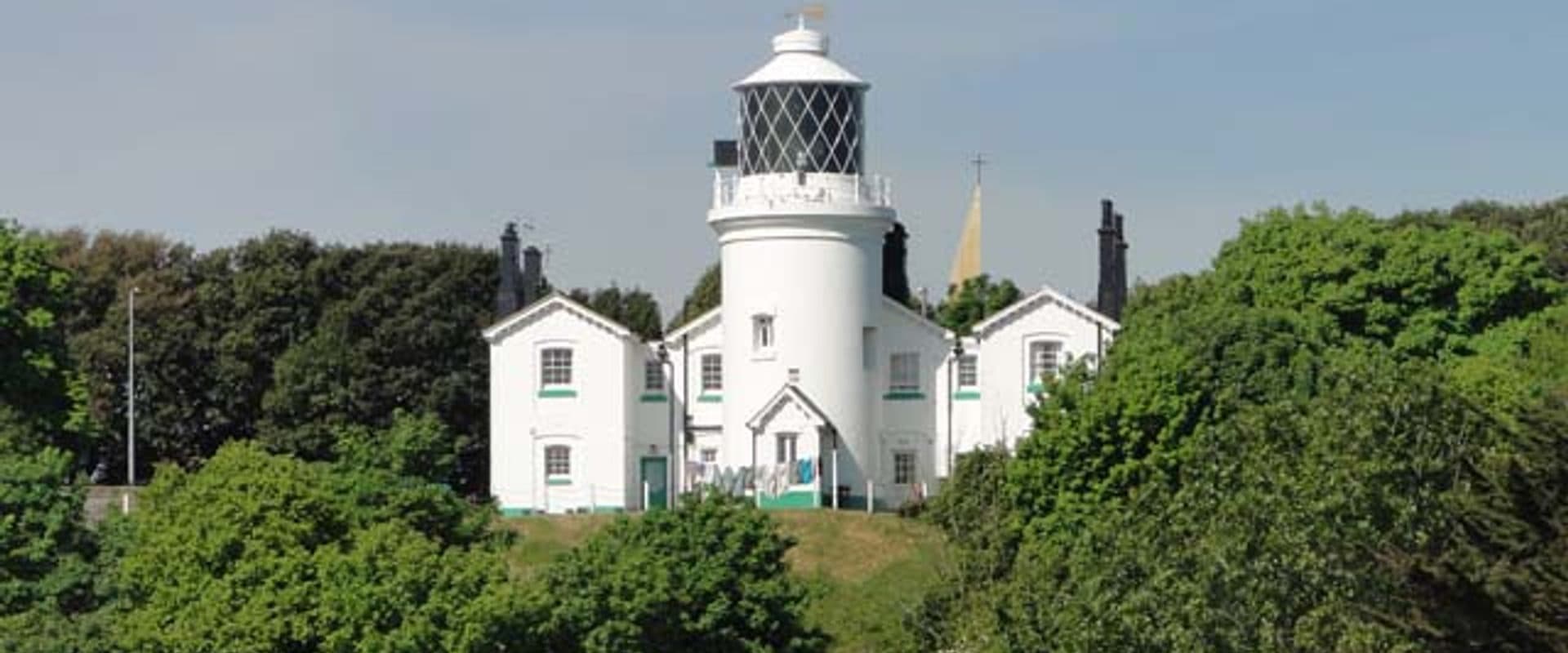 Lowestoft's white lighthouse tower rising above the seafront promenade on England's most easterly coast