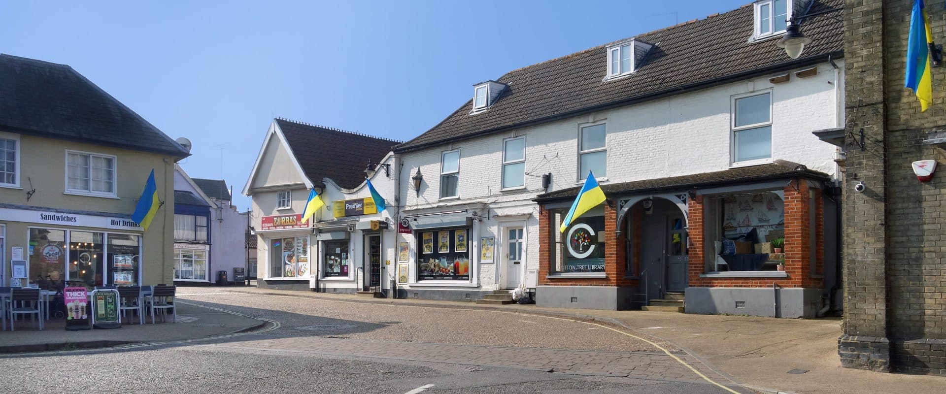 Saxmundham's Market Place lined with shopfronts in the town centre