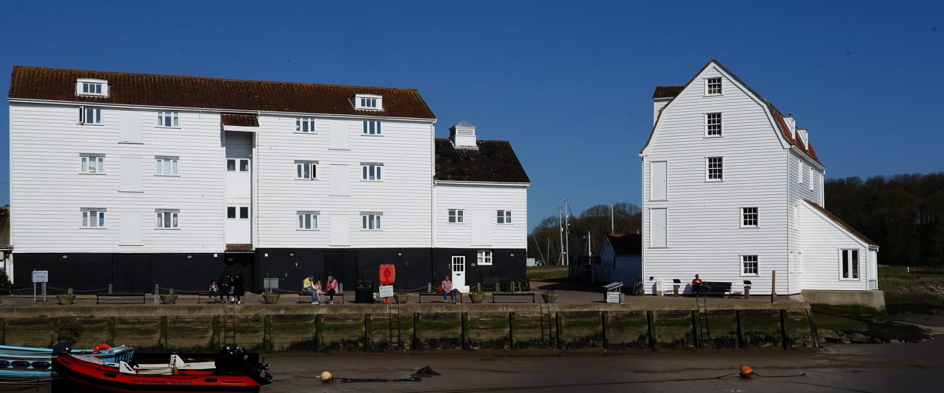 The white-boarded 18th-century Woodbridge Tide Mill on the banks of the River Deben, one of only two working tide mills in the UK